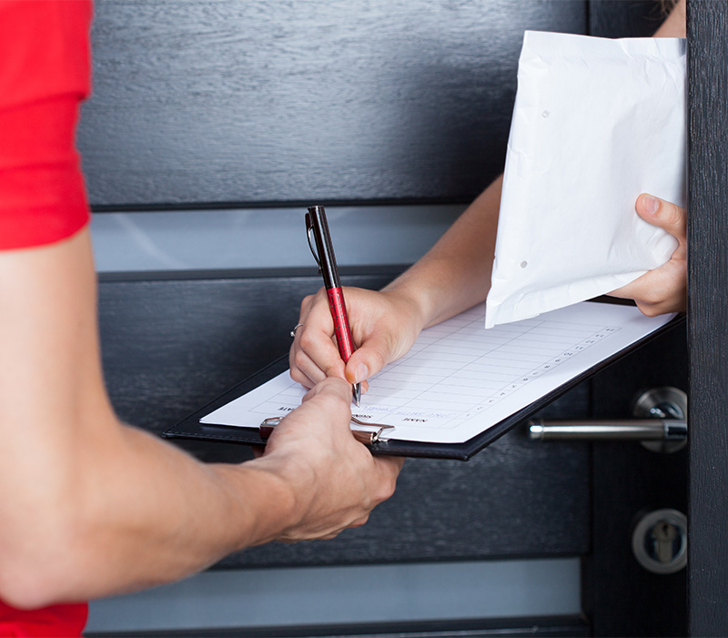 Woman signing package delivery papers